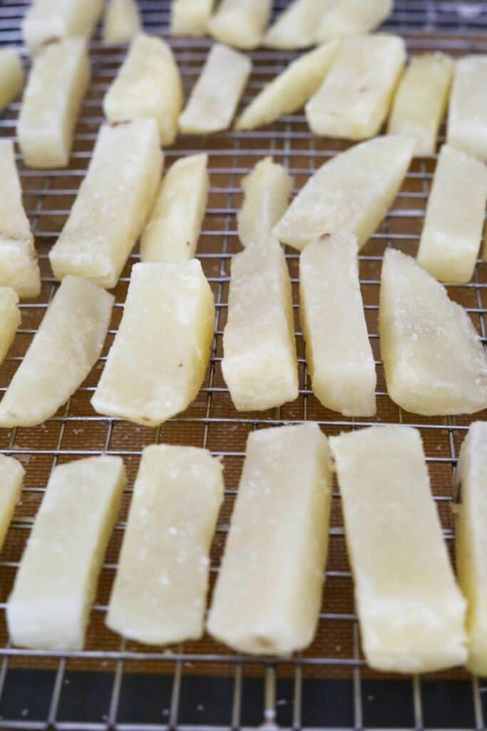 Chips on a cooling rack after the first fry