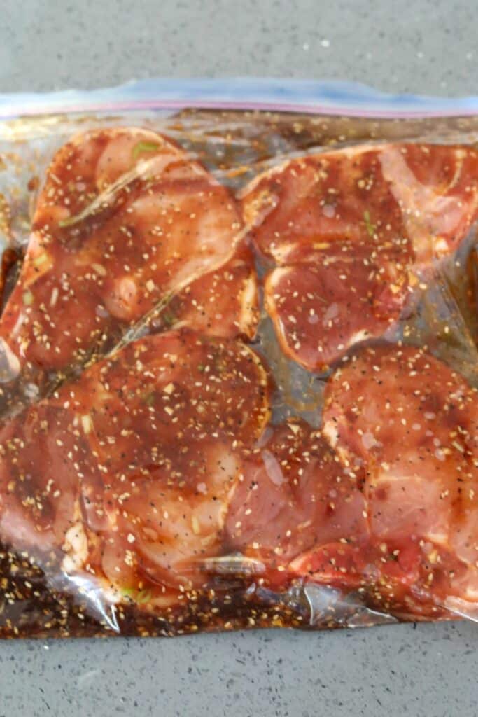 Pork chops marinating in a plastic bag