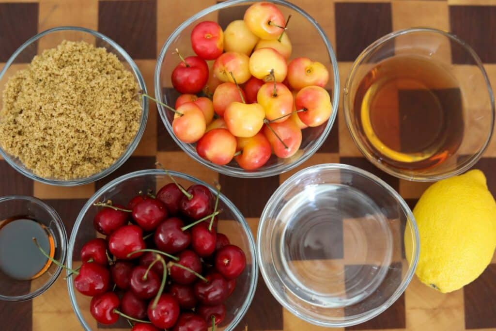 Ingredients for cherries jubilee on a wooden cutting board