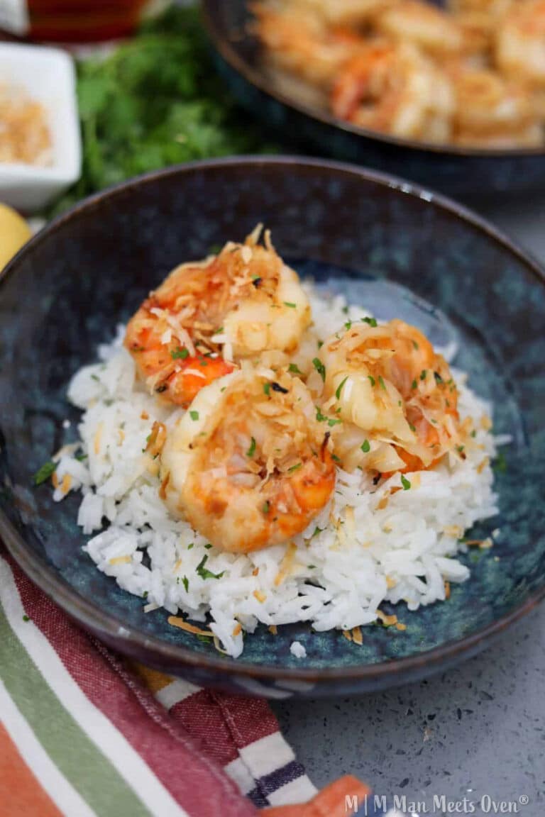 Coconut and rum shrimp in a blue bowl over rice