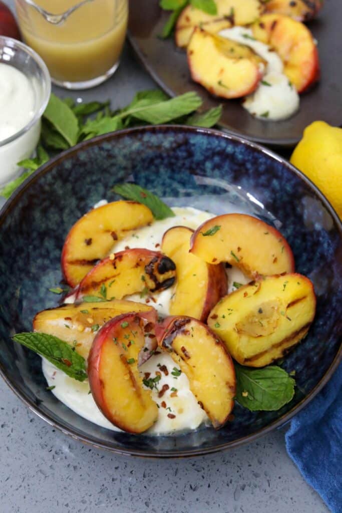 A bowl of grilled peach salad