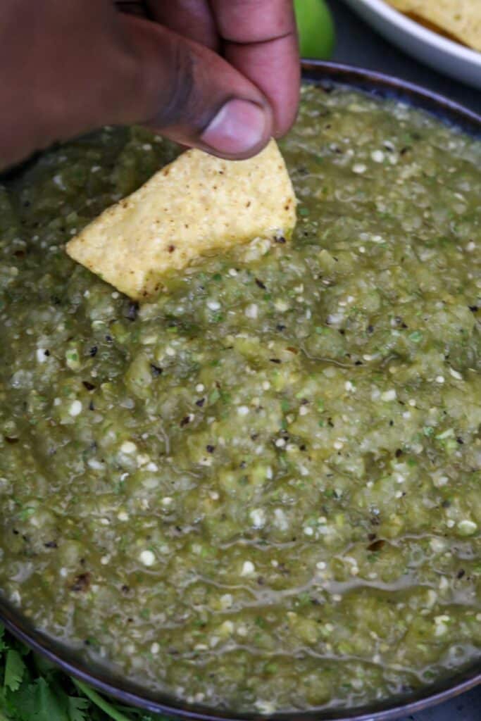 Dipping a chip into the salsa verde