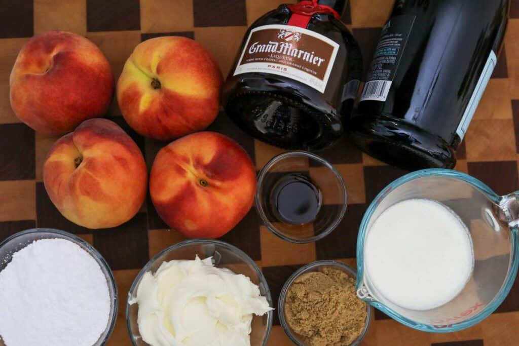 Ingredients for prosecco peaches on a wooden cutting board