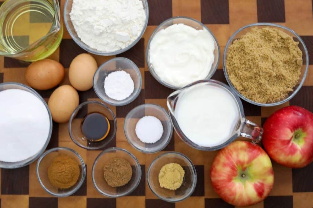 Ingredients for apple cake on a wooden cutting board
