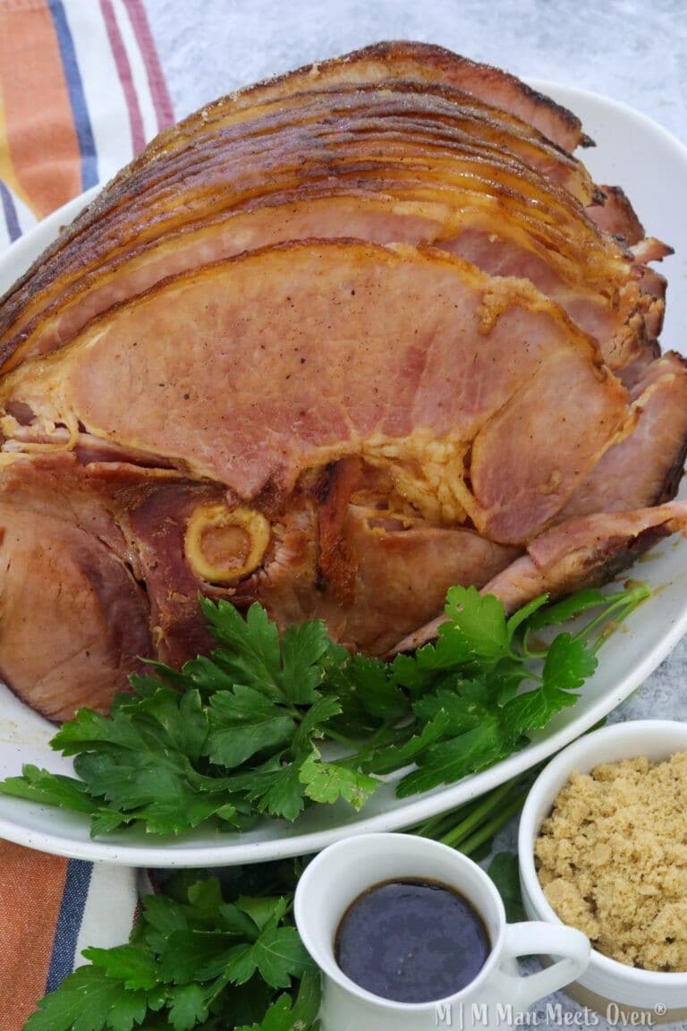 Bourbon and maple baked ham on a white platter