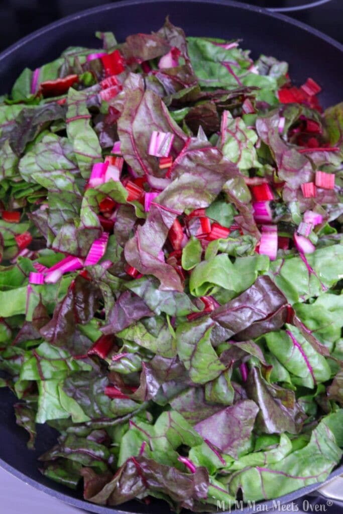 Uncooked swiss chard in a sauté pan