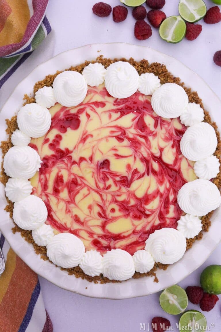Raspberry key lime pie in a white pie pan
