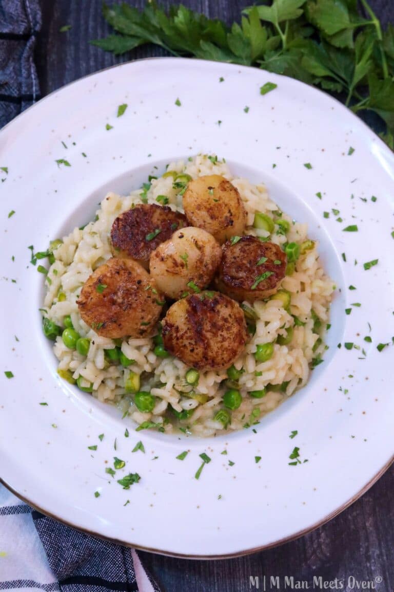 Birds eye view of pea and asparagus risotto with blackened scallops
