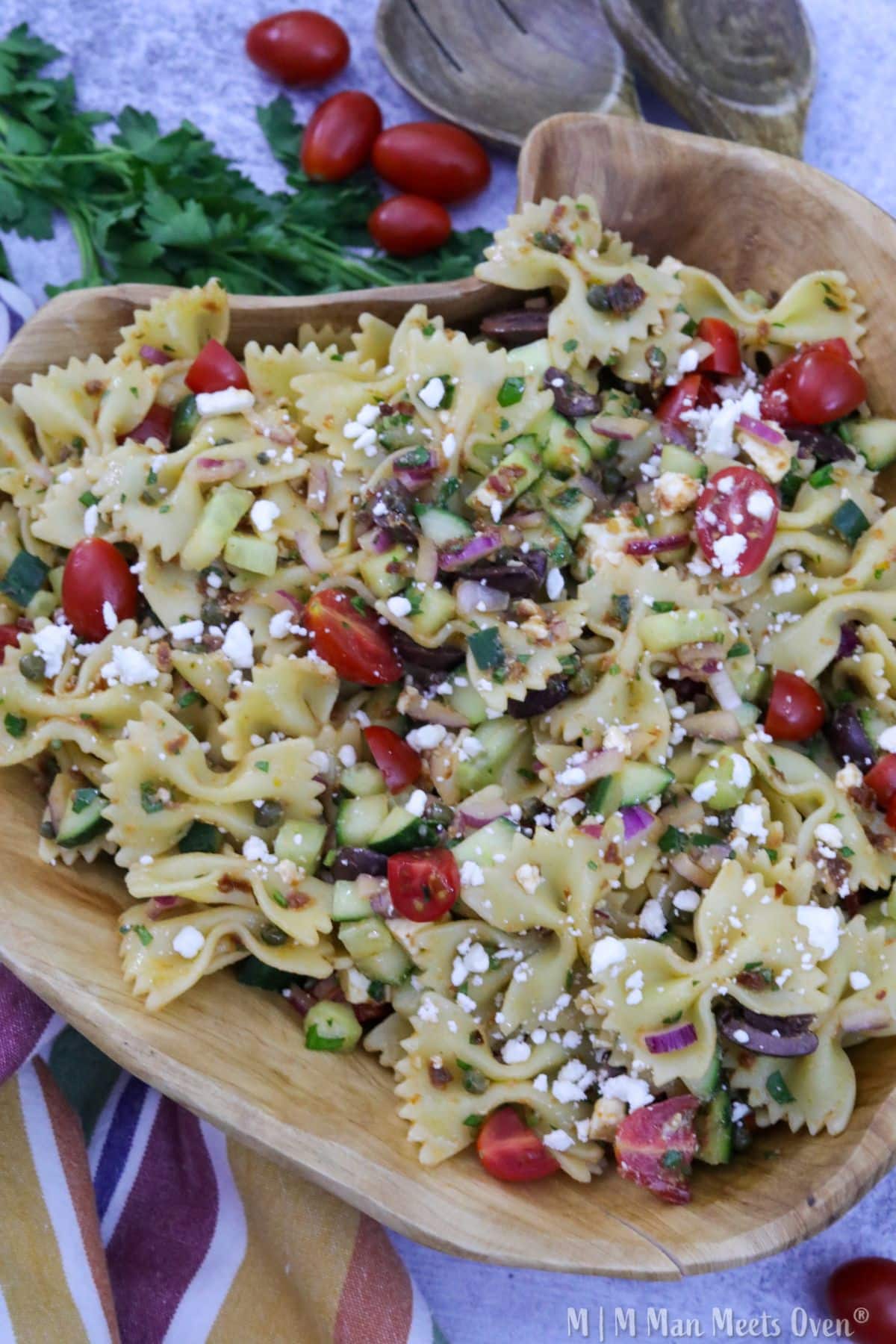 Mediterranean pasta salad in a wooden bowl