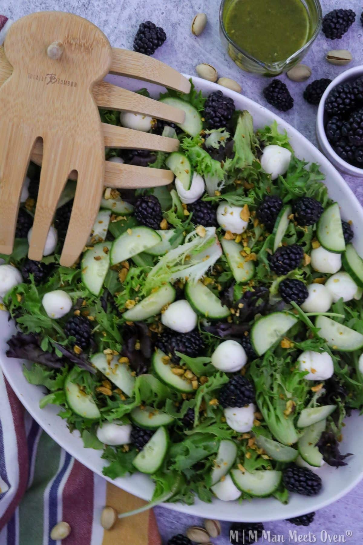 A birds eye view of blackberry and mozzarella salad in a white bowl