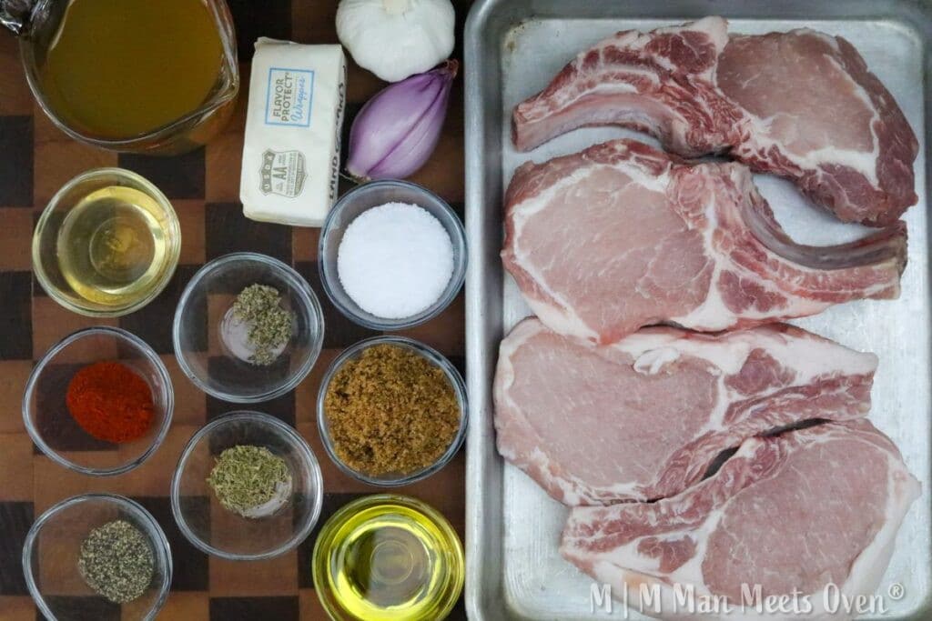 Ingredients for brown sugar pork chops on a wooden cutting board