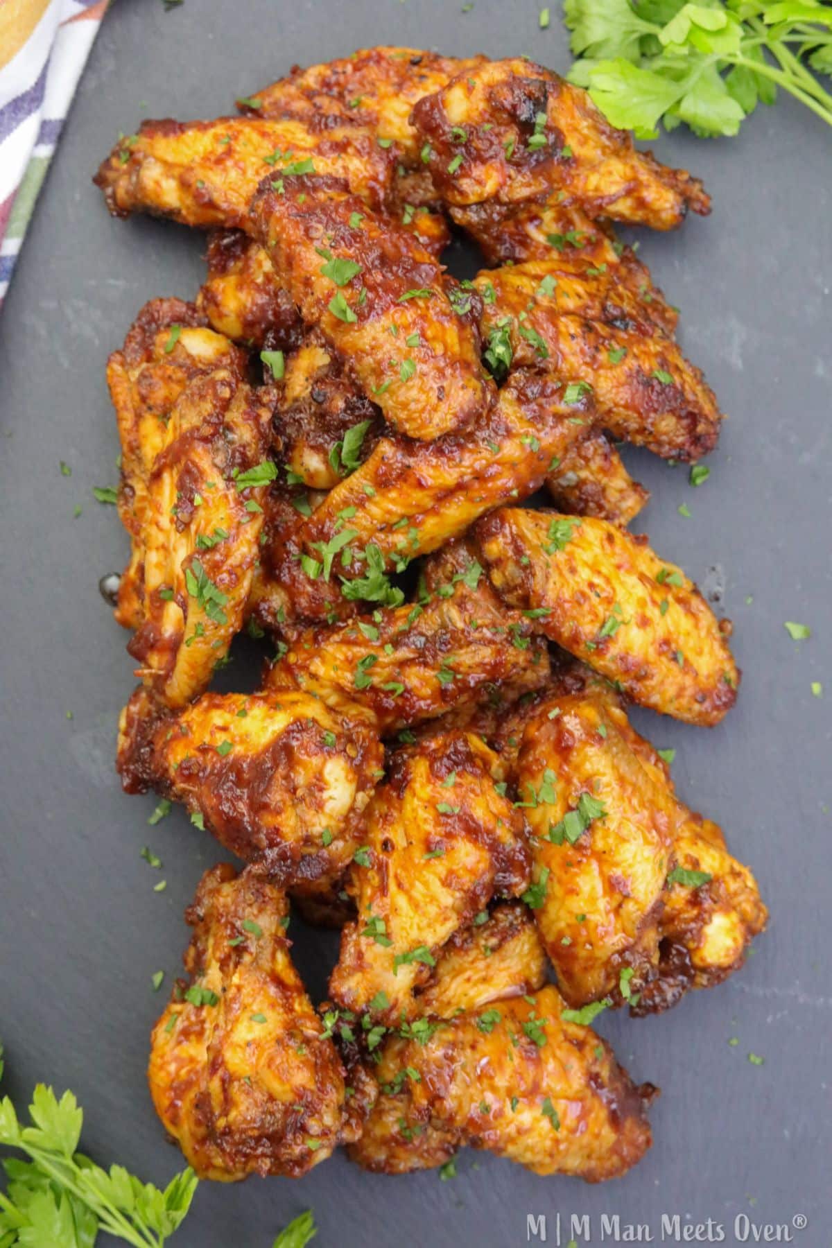 A slate plate with chipotle honey glazed chicken wings