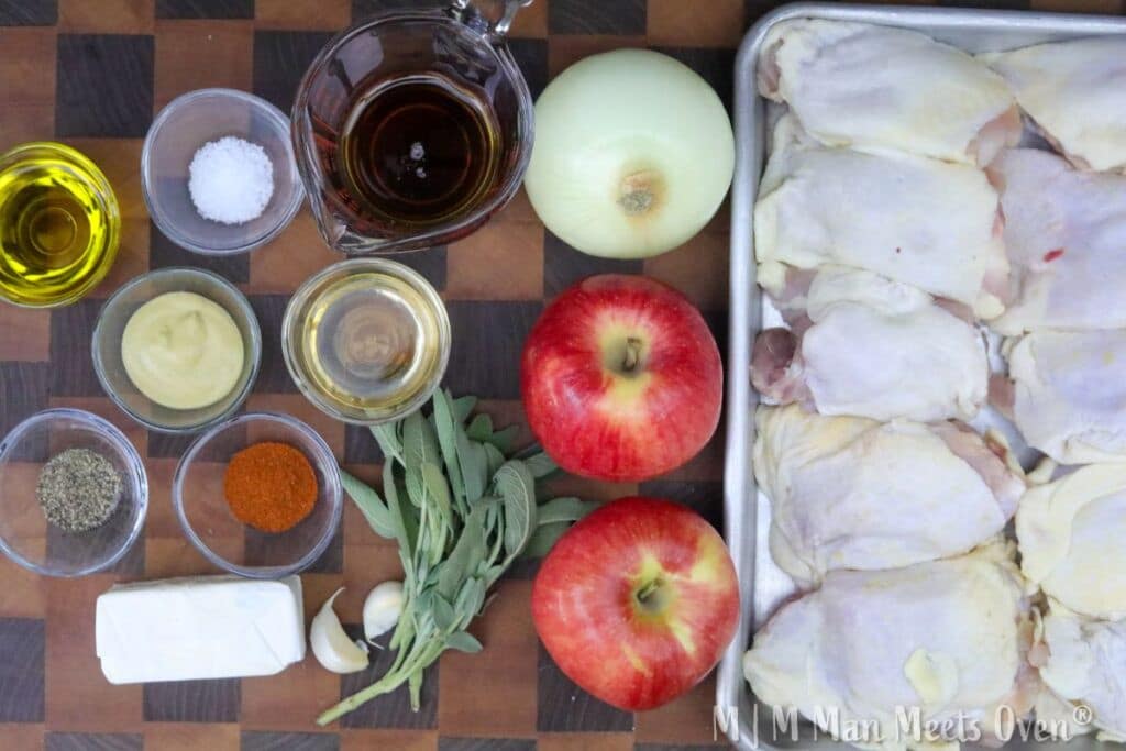 Ingredients for maple dijon chicken on a wooden cutting board