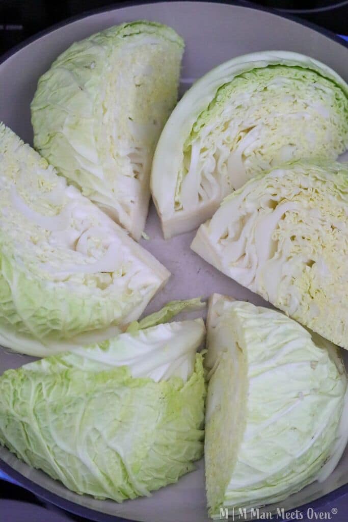 Cabbage wedges cooking in a pan