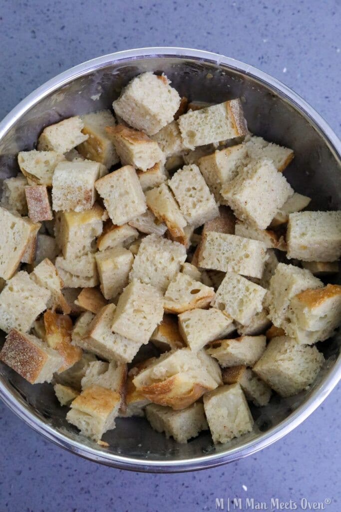 Cubed bread in a mixing bowl
