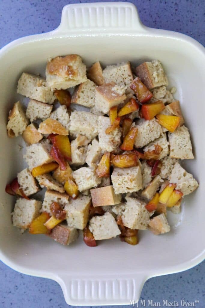 Cubed bread with peaches in dish