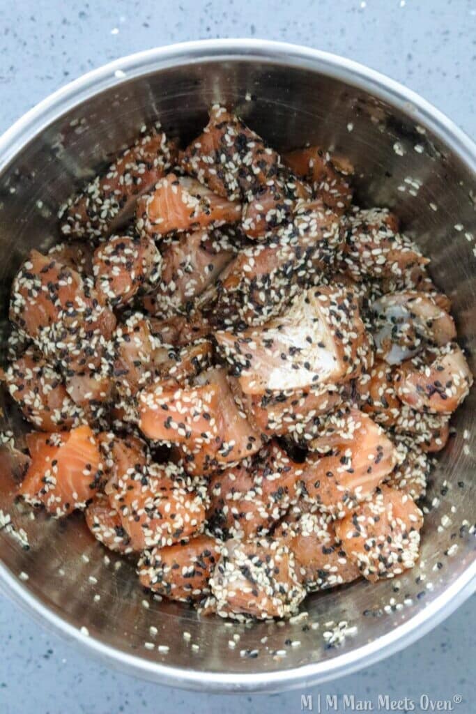 Salmon pieces coated in sesame seeds.