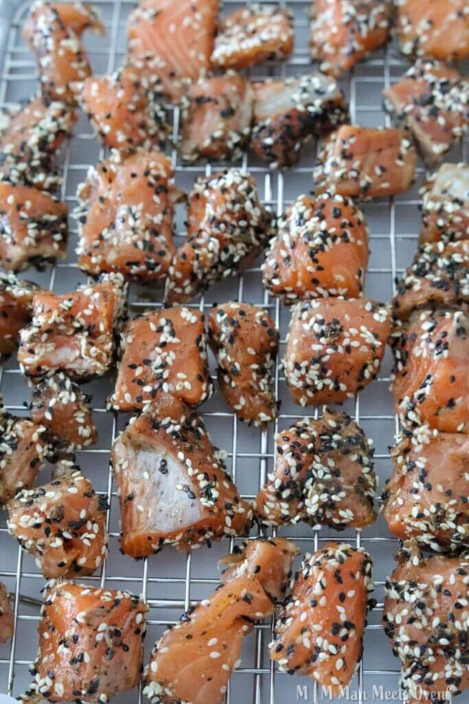 Raw salmon pieces with sesame seeds