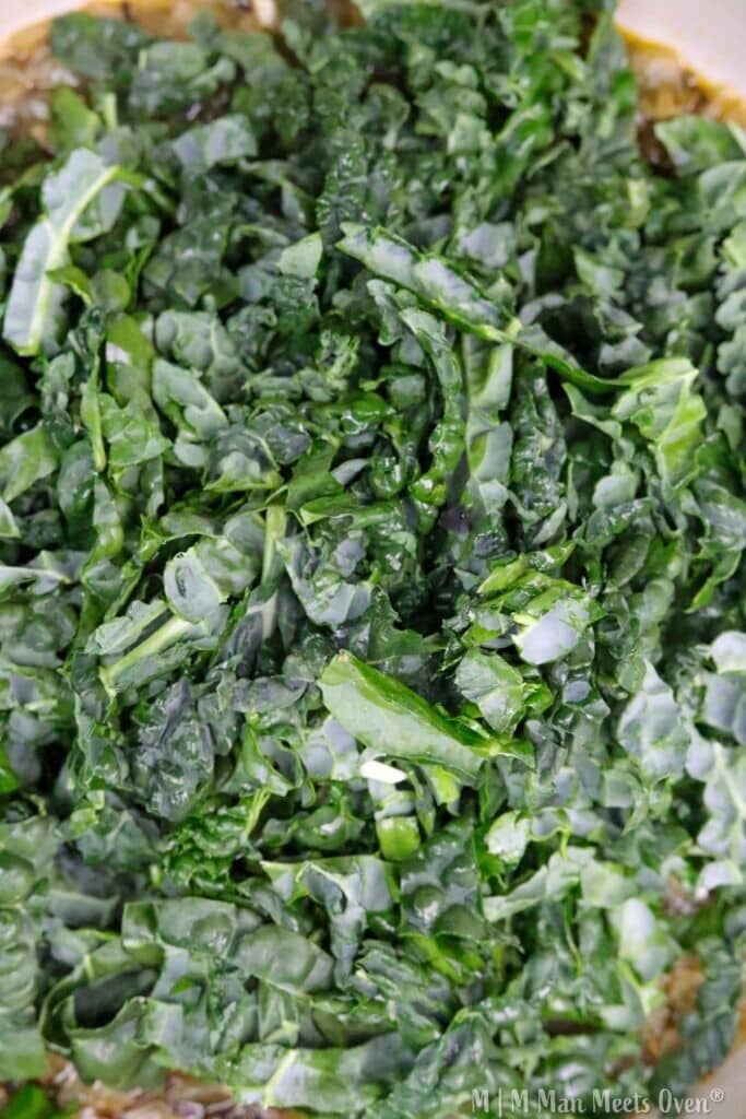 Chopped kale on a cooking surface.