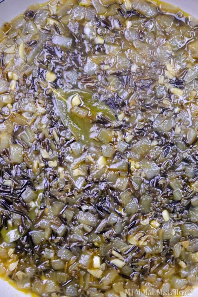 Cooked wild rice with vegetables and broth.