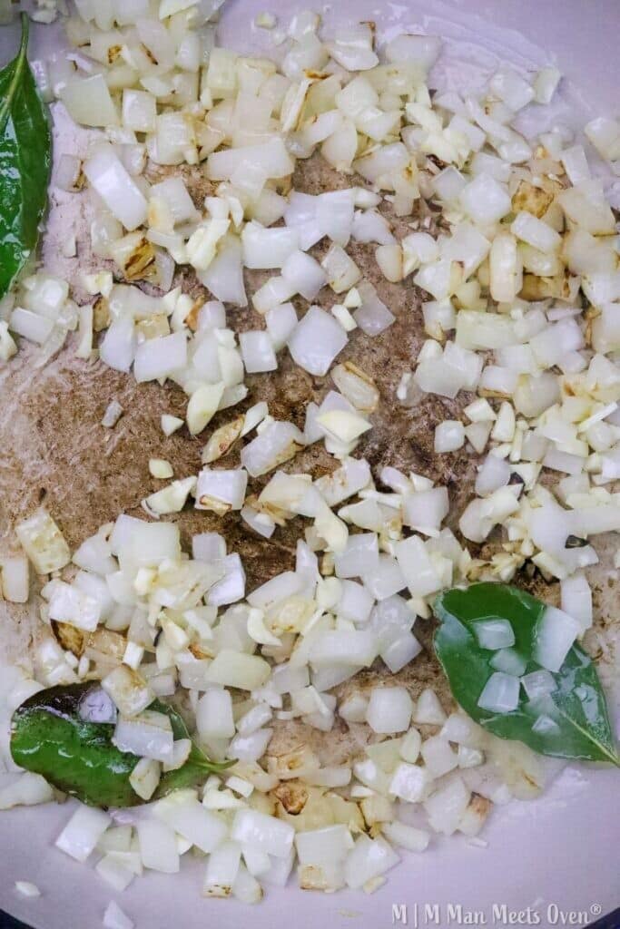 Chopped onions and greens in pan
