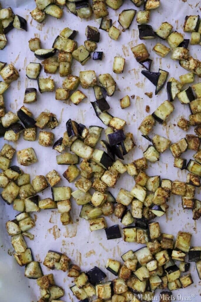 Chopped roasted eggplant on baking sheet