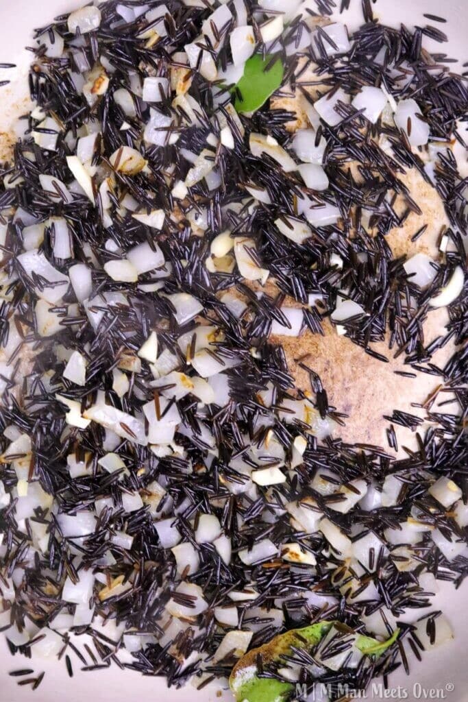 Cooked wild rice with onions and herbs